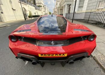 red ferrari 458 italia parked on road side during daytime